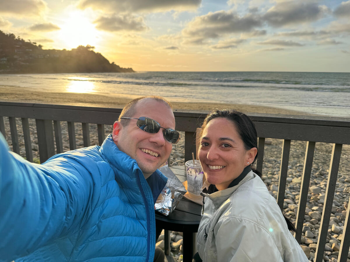 Untitled Michael and Michelle selfie with an ocean sunset in the background, on the beach.